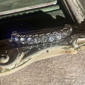 Curved crystal brooch